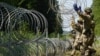 Lithuania toughens Belarus border with razor wire to bar migrants