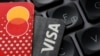 Illustration shows Euro banknotes, Visa and Mastercard cards