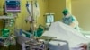 RUSSIA -- A medic wearing special suit to protect against coronavirus treats a patient with coronavirus at the City hospital No. 52 for coronavirus patients in Moscow, June 17, 2021